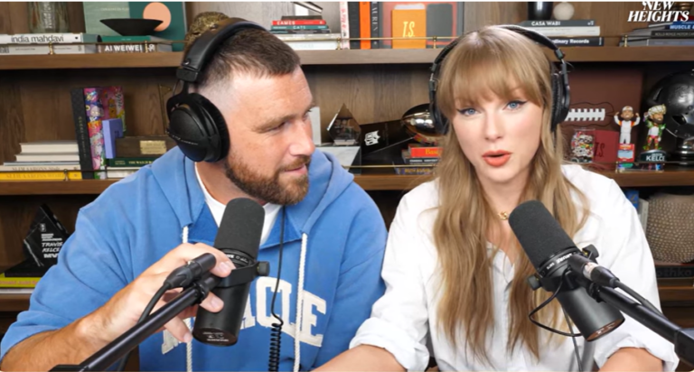 Travis Kelce looks at Taylor Swift during Wednesday's episode of New Heights.