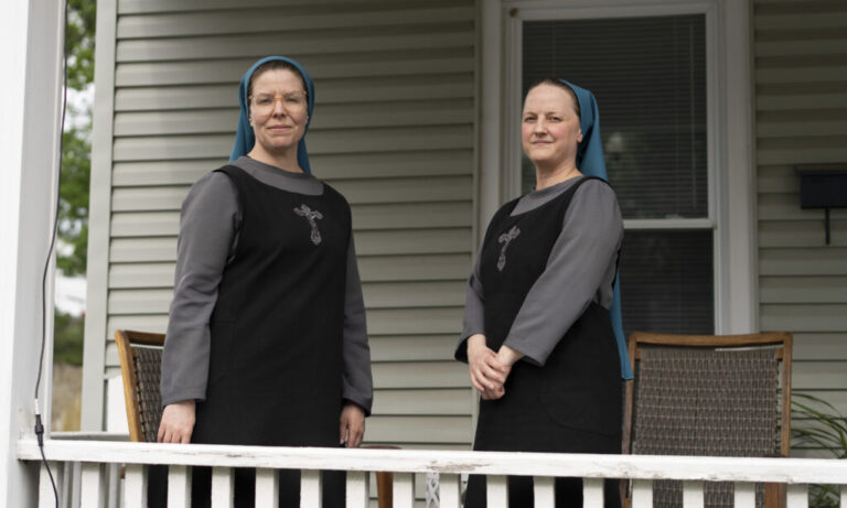 Sisters of the Little Way, Sister Danielle Lussier and Sister Theresa Theresa Aletheia, pose for a portrait on the front porch of their home in Mt. Sterling, Ky., in April.