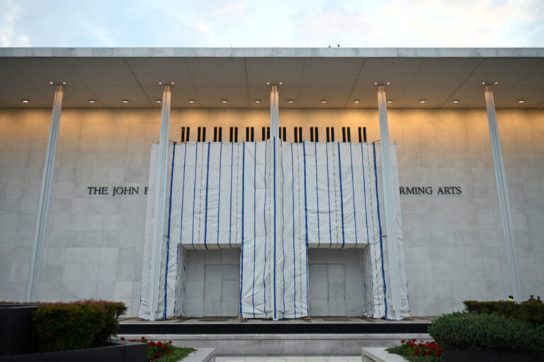 The Kennedy Center, the facade of which remains covered with a tarp, is seen in Washington, DC, on June 28, 2026. A US federal judge asked on June 24 for an explanation for why a tarpaulin continues to cover the facade of the Kennedy Center where President Donald Trump's name was recently removed. District Judge Christopher Cooper gave the board of trustees of the performing arts venue until the end of July to explain