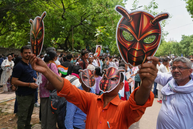 Supporters of the Cockroach Janta Party wear and display masks during a protest in New Delhi, Saturday.