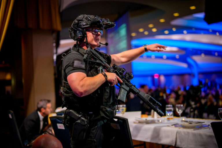 Armed Secret Service agents stand on stage during a shooting incident at the annual White House Correspondents Association Dinner at the Washington Hilton on April 25, 2026 in Washington, DC. President Donald Trump, along with other government officials, were evacuated from the Washington Hilton after reports of gun shots.