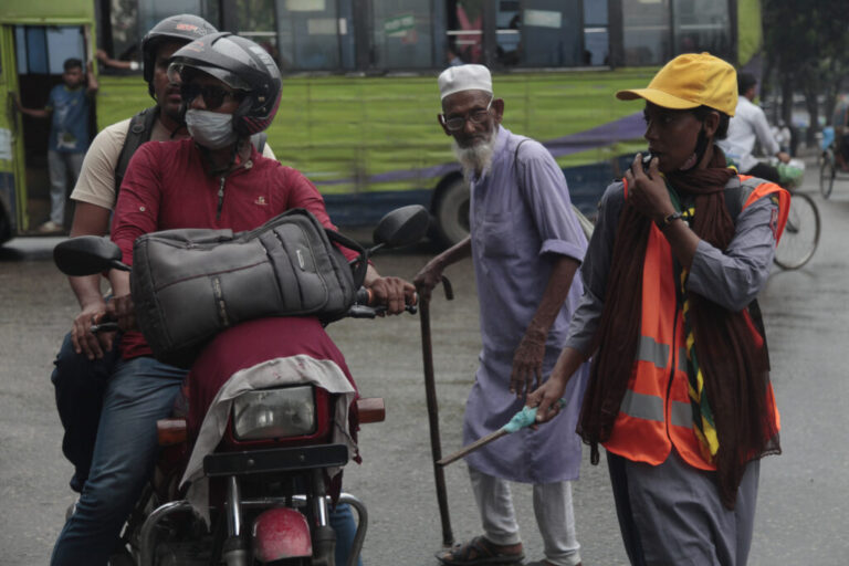 Shahana Akhtar directs traffic at a busy intersection. She’s 26 and wears her girl’s scout uniform to give her more authority as she controls traffic. Akhtar supported the students’ movement to oust the former prime minister Sheikh Hasina, and hopes the new interim government will create more jobs. She says she’s never had a paid job.