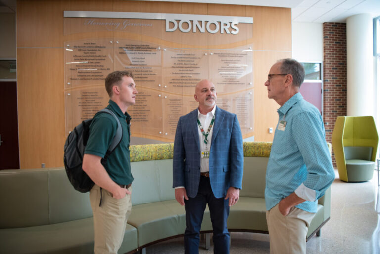Nursing student Connor Aderholt speaks with professors Curry Bordelon and Gregory Eagerton in the lobby of the University of Alabama at Birmingham School of Nursing.