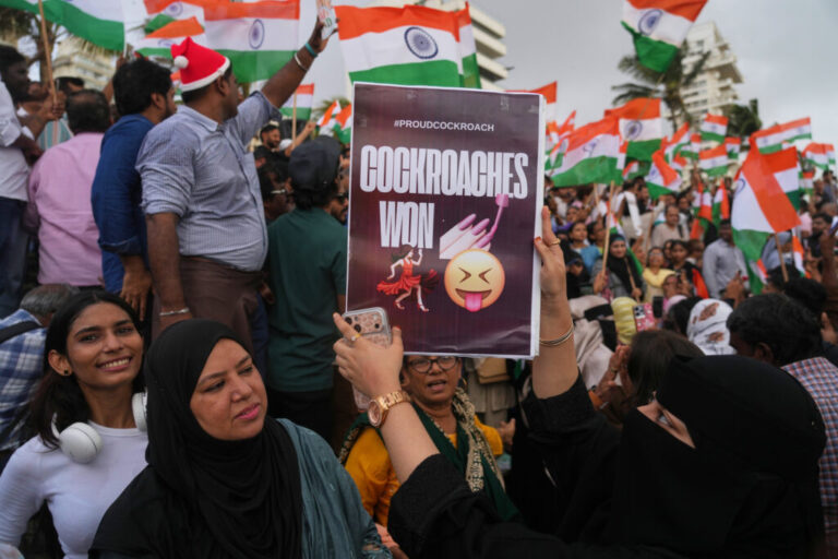 A protester holds a placard after India's Education Minister Dharmendra Pradhan resigned following nationwide protests as part of the Cockroach Janta Party's protest movement in Mumbai, India on Saturday.