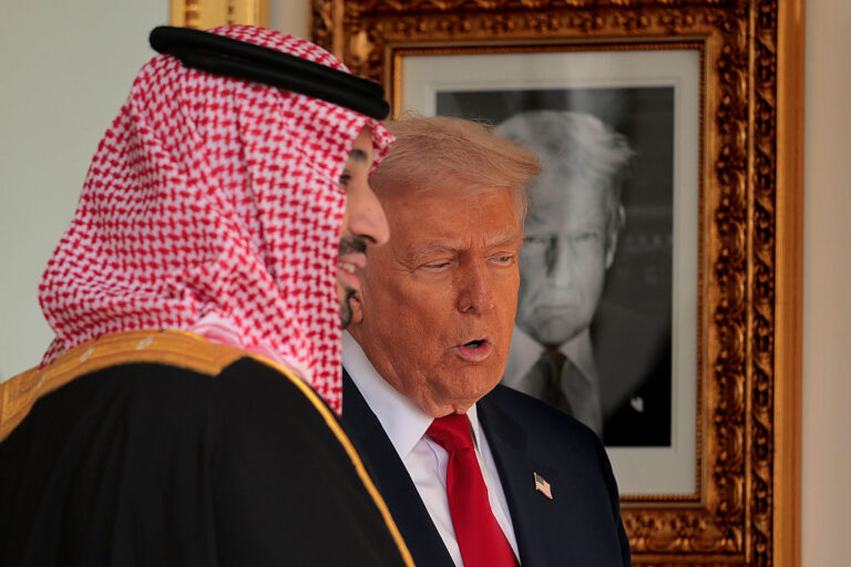 With a photograph of himself on the wall as part of
