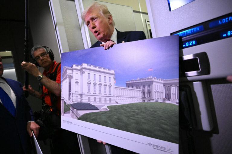 President Trump holds a rendering of the East Wing modernization while speaking to reporters aboard Air Force One on Sunday.