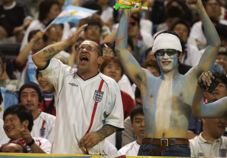 England and Argentina fans sit side by side during the FIFA World Cup match in Sapporo, Japan, on June 7, 2002. England won 1-0. The old rivals meet again this year in a World Cup semifinal showdown.