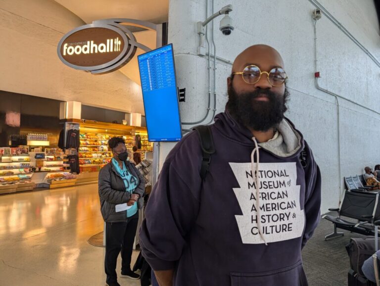 Standing inside an airport, Lee Collins waits for his flight back to Atlanta from Washington, D.C., on April 28.