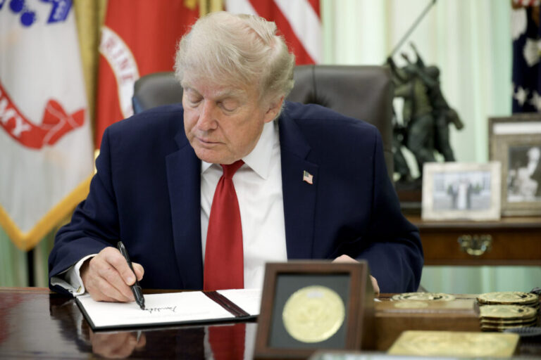 U.S. President Donald Trump signs an executive order at the White House.