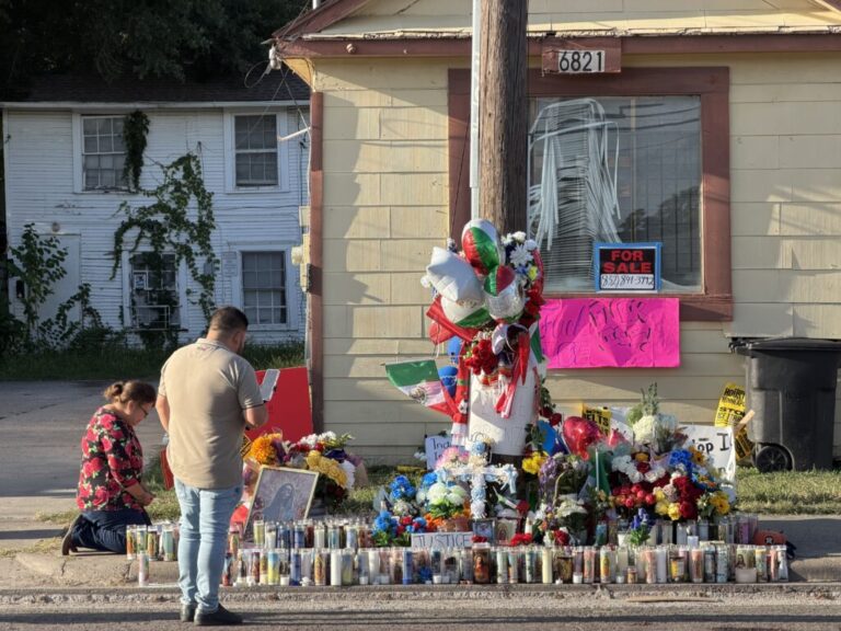 Mourners including María Guadalupe Rodríguez, kneeling, pay their respects in front of a makeshift memorial for Lorenzo Salgado Araujo, a Mexican immigrant shot and killed by immigration agents in Houston.
