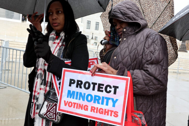 Demonstrators hold a sign saying “PROTECT MINORITY VOTING RIGHTS” outside the U.S. Supreme Court in Washington, D.C., in 2025.