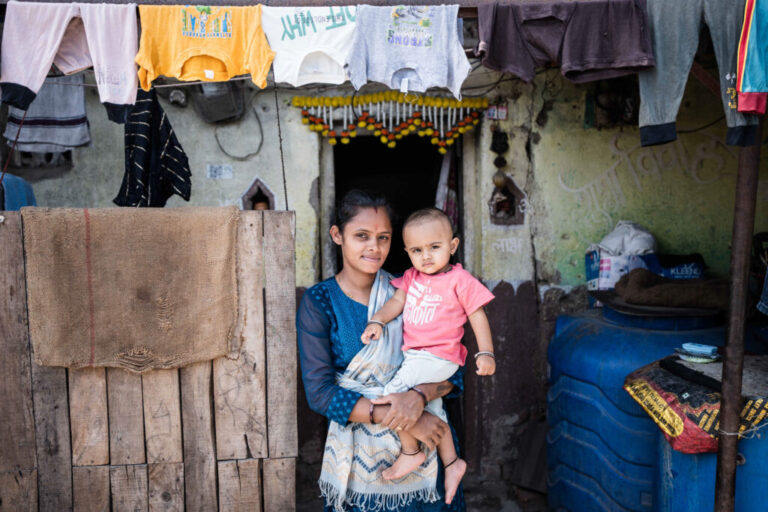 Sanjaynagar slum resident, Pooja Suryavanshi's (26), and her child, Rudransh, outside their home or 'dwelling unit'.