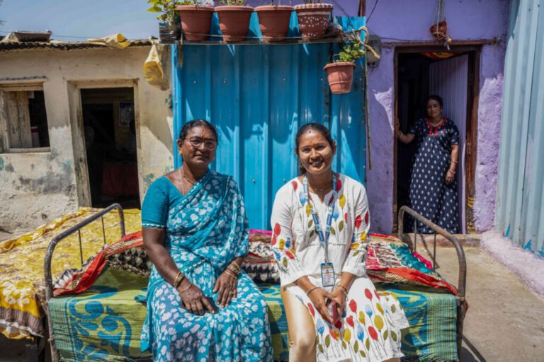 30 year old Anjali Naydu, another community representative, said that they had meeting after meeting with the members of the community to get them to believe in the redesign project. Here she sits with her mother outside her home in the Sanjaynagar slums. 5 of her aunts live in the same area. Her family is waiting for construction to begin on their land.