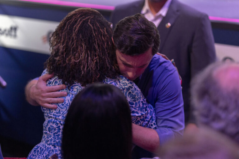 Sen. Jon Ossoff hugs Felicia Murray Jackson after speaking during a campaign rally at Center Stage in Atlanta, Georgia, August 16 2026. Jackson is the sister of Linda Davis, a special education teacher, who was killed during a traffic stop conducted by the United States Immigration and Customs Enforcement in Savannah, Georgia.