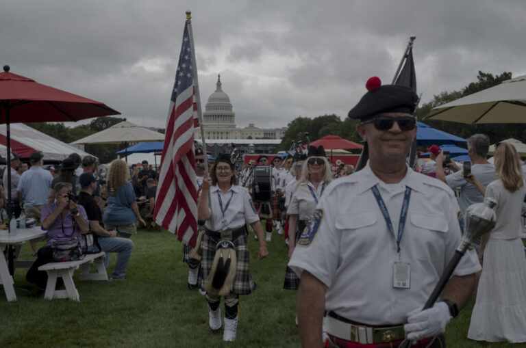 The Indianapolis 500 Gordon Pipers march down the National Mall during the Freedom 250 Grand Prix.