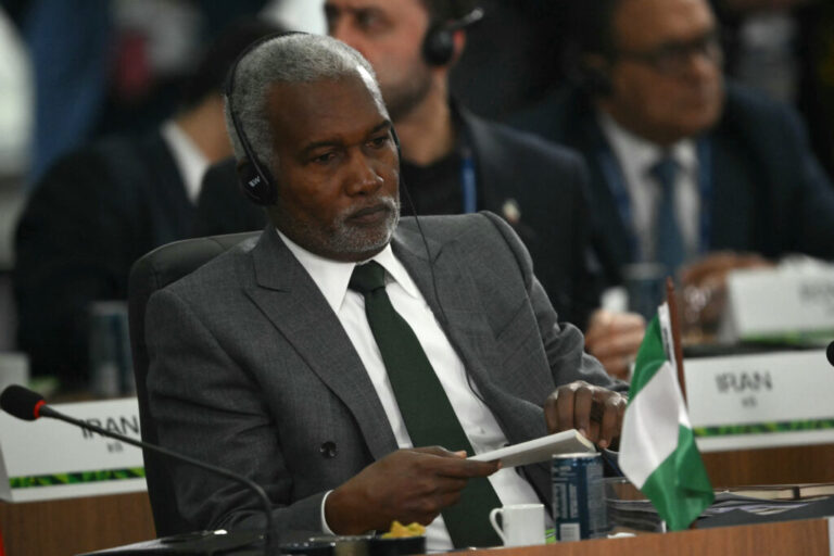 Yusuf Tuggar, Nigeria's foreign affairs minister, is seated at a summit in Brazil in 2025. He's wearing a suit and is wearing headphones.