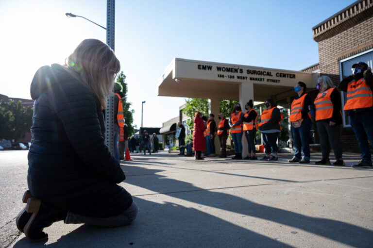 Abortion-rights advocates think the Trump administration's limits on enforcing the FACE Act give a green light to anyone who wants to disrupt abortion centers in the future. Here, an anti-abortion demonstrator is shown before a line of volunteer clinic escorts in front of the EMW Women's Surgical Center, an abortion clinic, in 2021 in Louisville, Kentucky.