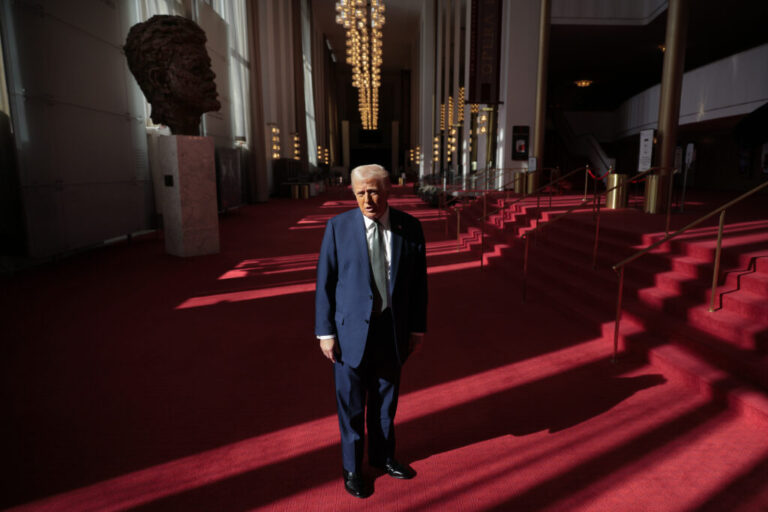 President Donald Trump talks to the media in the Hall of Nations during a tour at the John F. Kennedy Center for the Performing Arts after leading a board meeting on March 17, 2025.