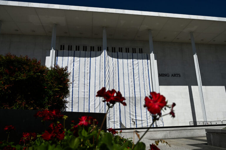 A photo of the exterior of the Kennedy Center in Washington, D.C., in June. For months, a tarp has covered the arts complex's facade, ever since a federal judge ruled that President Trump's name was unlawfully added to the center.