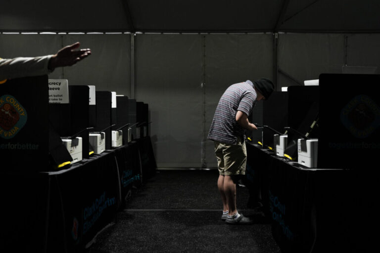A voter casts a ballot at a vote center set up in a tent in Las Vegas on June 9.