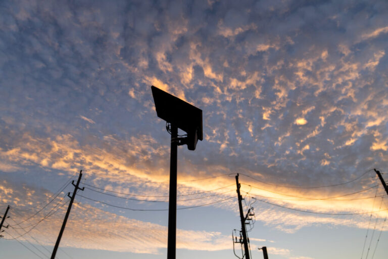 A Flock Safety license plate reader is seen last year along a public road in Houston.