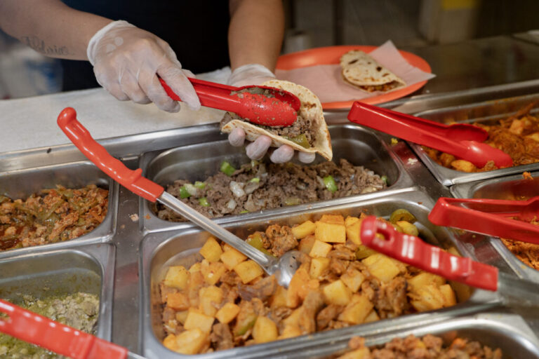 A worker at Monchy's prepares a taco order for a customer at the restaurant in Houston, Texas, on July 11, 2026.