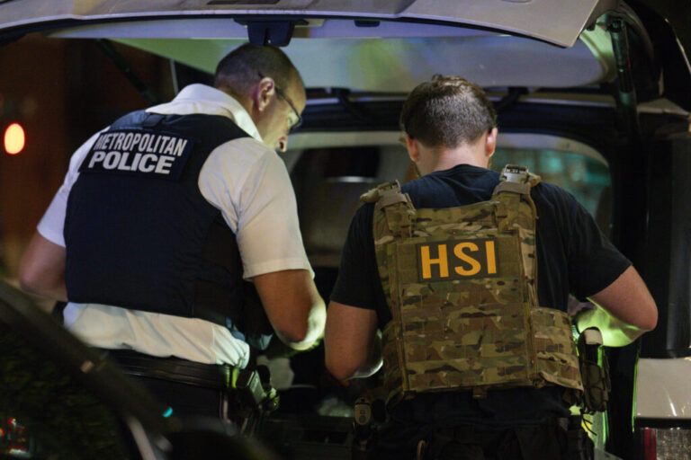 Metropolitan Police Department and Homeland Security Investigations officers search inside a car during a traffic stop on Aug. 14, 2025, in Washington, D.C.