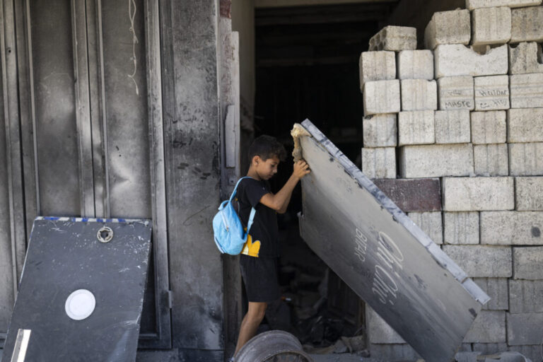 A boy removes a metal sheet to enter the old market of Nabatiyeh, heavily damaged by the war. The city is full of destroyed and damaged buildings after nearly all of its 80,000 residents were displaced by Israeli bombardments and evacuation orders.