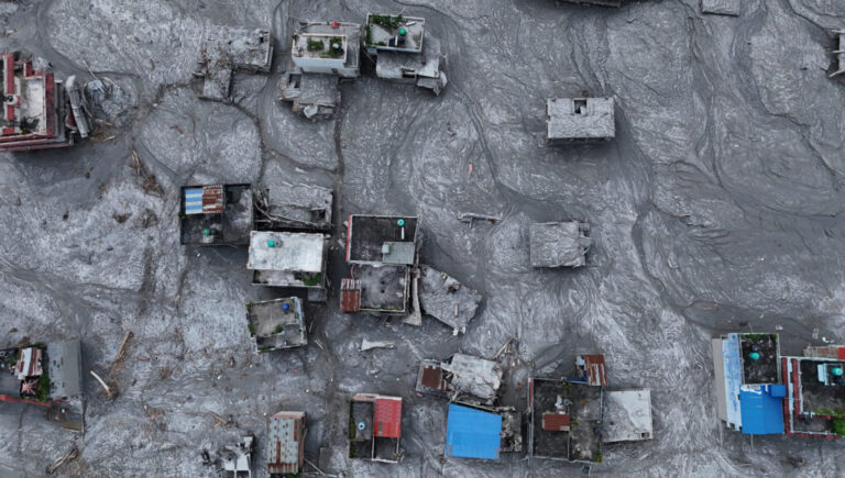 An aerial view shows debris and mud covering an area following flash floods on August 28, 2026 in DevGhat village, Nepal.
