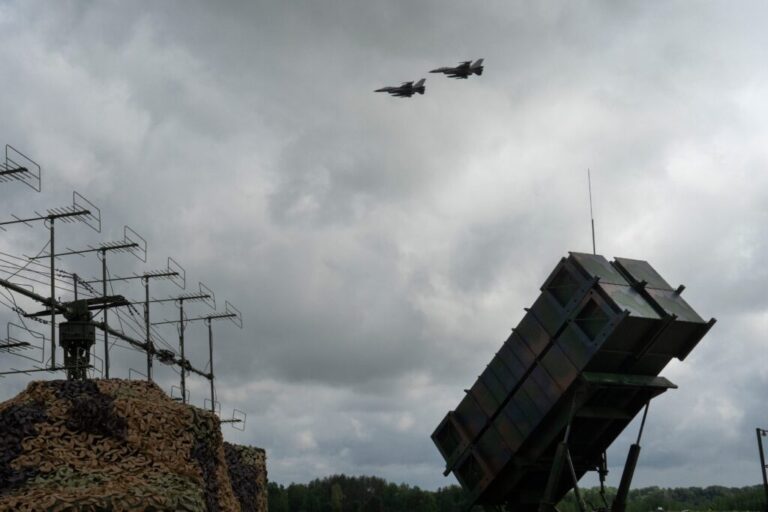 Ukrainian Air Force F-16 fighter jets fly over a Patriot air and missile defense system in an undisclosed location in Ukraine, on Aug. 4, 2024.