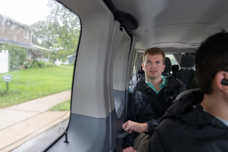 Cody Brendle rides in a van on a group outing to the grocery store with Next Steps.