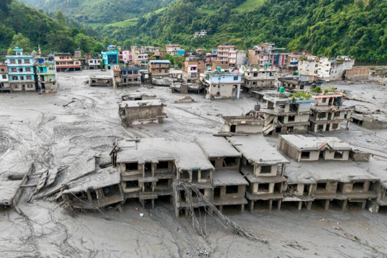 An aerial view shows houses lying deluged in sludge after flash floods at Devighat, Bidur Municipality in Nepal's Nuwakot district on August 27, 2026.