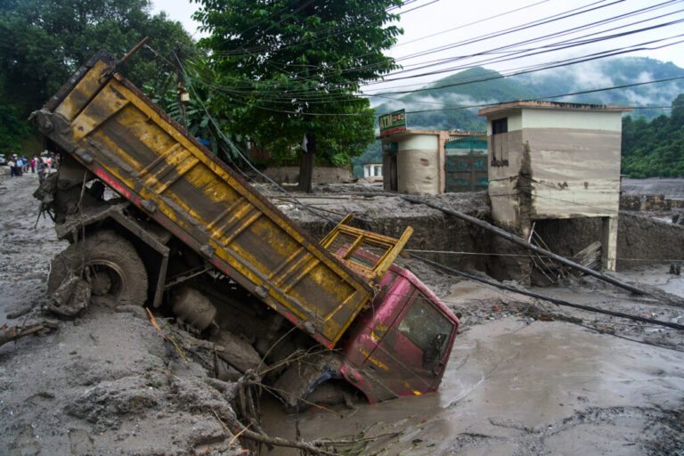 A vehicle is seen in the aftermath of flash floods in Devighat in the Nuwakot district in Nepal.