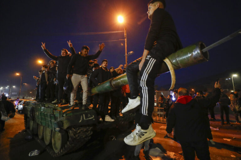 Syrians celebrate the arrival of opposition fighters in Damascus, Syria, on Sunday.