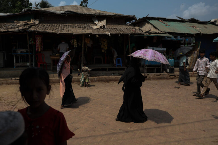 People walk past vendor stalls in a Rohingya refugee camp in Cox's Bazar, Bangladesh, April 21, 2026.