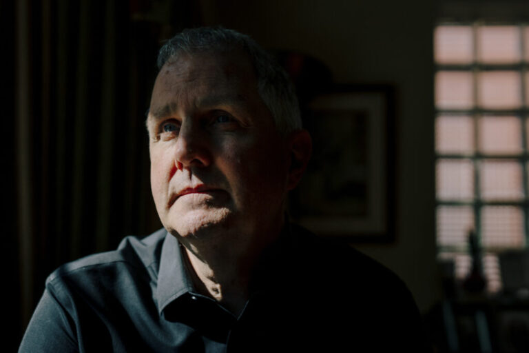 Michael Rabbitt, a longtime Chicago community organizer who was among the Broadview 6 protesters, sits for a portrait in his home on July 29, 2026, in Chicago, Ill. Rabbitt was one of six people charged with federal conspiracy offenses following a 2023 protest outside an ICE facility in Broadview, Illinois. The charges were later dismissed after a judge found prosecutorial misconduct.
