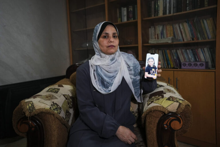 Hind Rajab poses in Gaza City, Wednesday, Aug. 19, 2026, with a photo of her granddaughter, Hind Rajab, a 5-year-old Palestinian girl who was killed alongside her family in Gaza in February 2024.