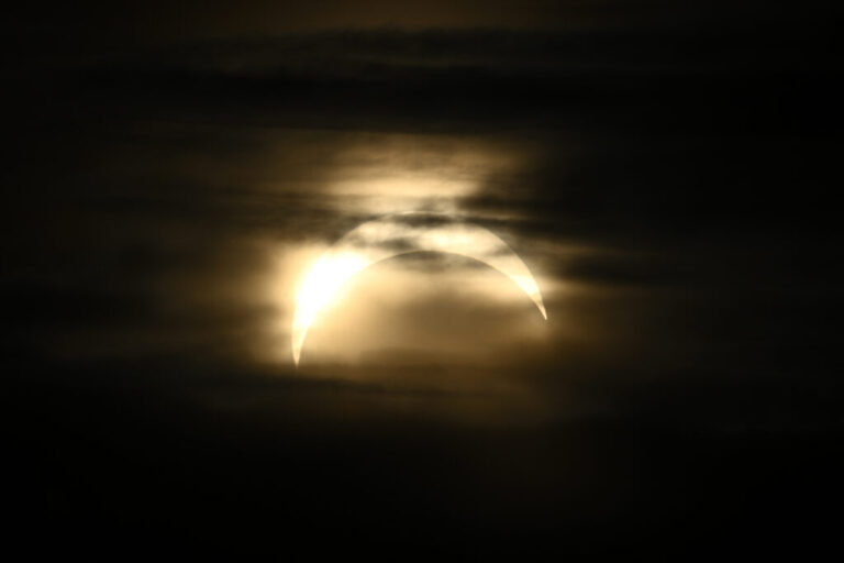 The partial eclipse is seen from Observatorielunden park in central Stockholm, Sweden.