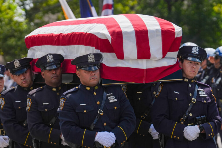 The casket of Staff Sgt. Angel S. Rampersad, who was killed in the ongoing war between the U.S. and Iran, is carried by NYPD officers during the funeral procession in New York on Friday, July 31.