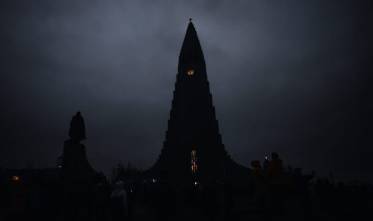 The Hallgrímskirkja church is seen in the dark during a total solar eclipse on a cloudy day in Reykjavik, Iceland.
