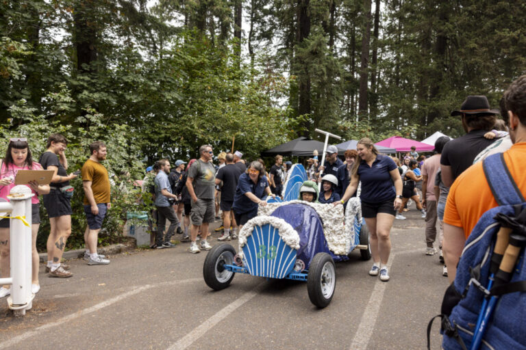 Racers at the Portland Adult Soapbox Derby guide their vehicles to the starting line on August 15, 2026 in Portland, Ore.