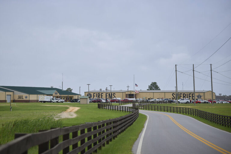 This photo from Walton County shows a compound comprising two large, low-slung buildings. The building on the left says