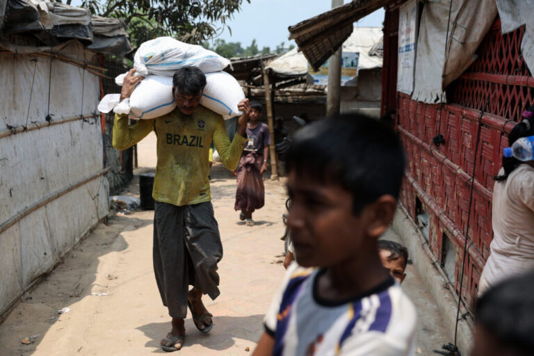 A man carries sacks on his shoulders in a Rohingya refugee camp in Cox’s Bazar, Bangladesh, April 21, 2026.
