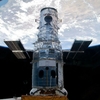 The Hubble Space Telescope in 2009, locked in a space shuttle's cargo bay, before the final repair work ever done.
