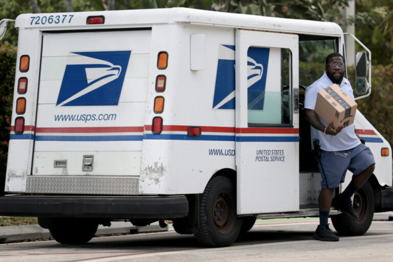 U.S. Postal Service mail carrier Marc Jacques makes a delivery in Miami in March.