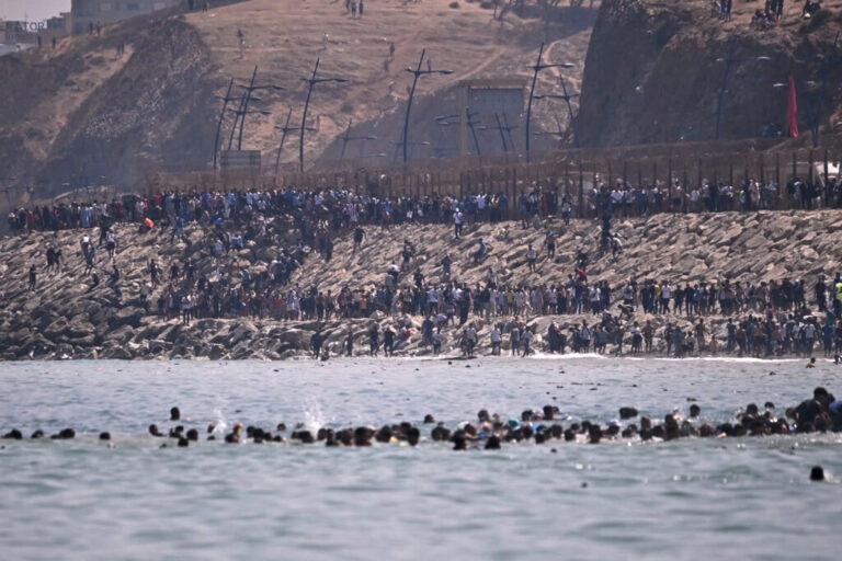 Migrants cross from Morocco into the Spanish enclave of Ceuta, Thursday, July 30, 2026.