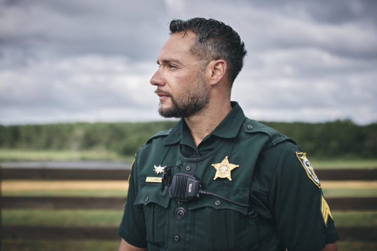 Photographed from about the waist up, Sergeant Oscar D’Lassalas stands outdoors, wearing his uniform.