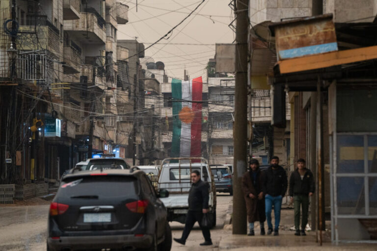 A Kurdish flag hangs down in the Kurdish city of Qamishli.