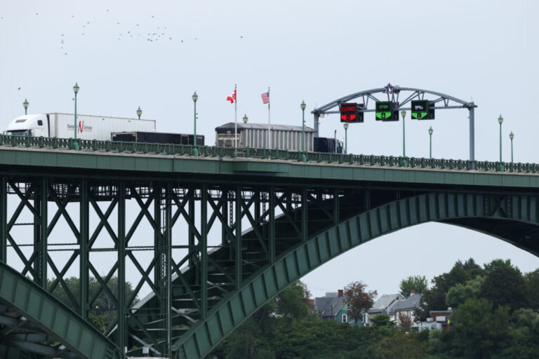 Tractor trailers cross the Peace Bridge at the Canada-United States border in Fort Erie, Ontario, Canada, on August 20.