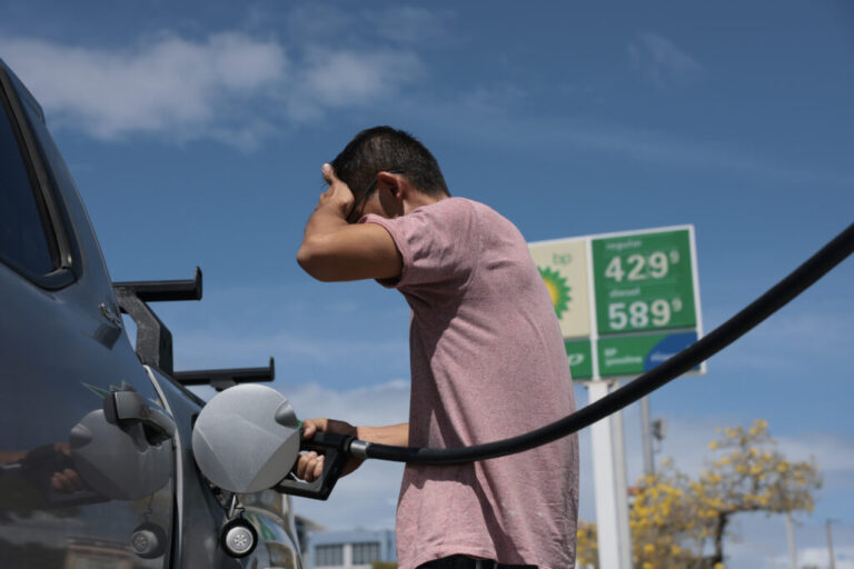 William Mao puts fuel in his vehicle at a gas station in Miami, Florida on April 6.
